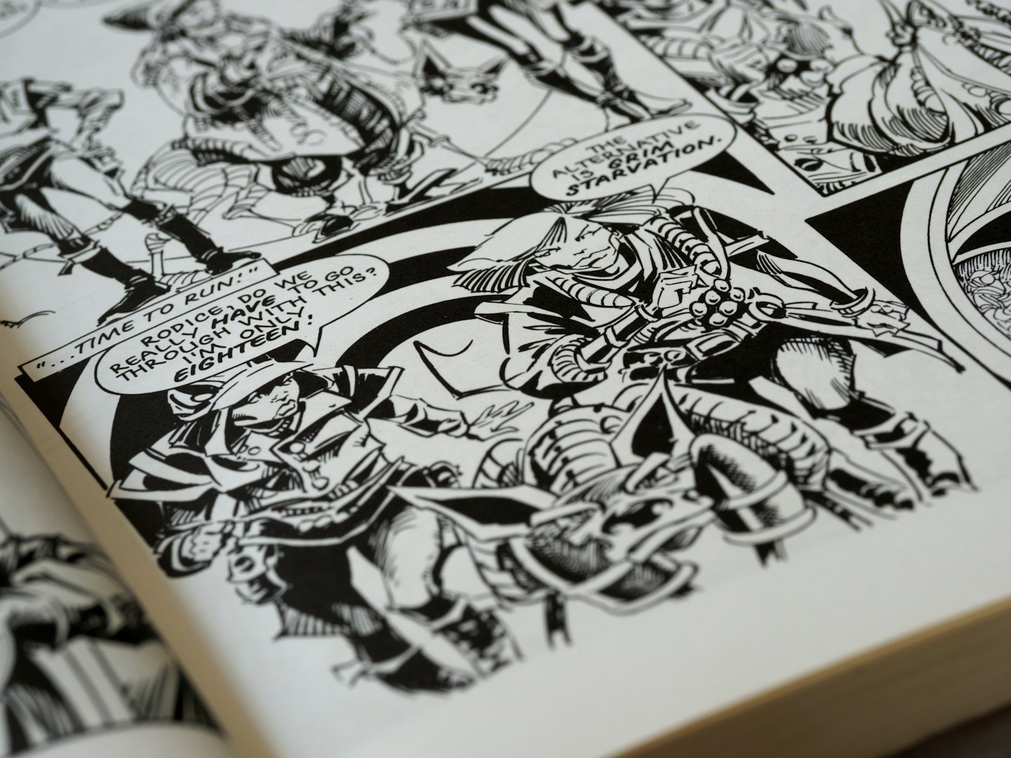 Open comic book page with detailed black and white illustrations.